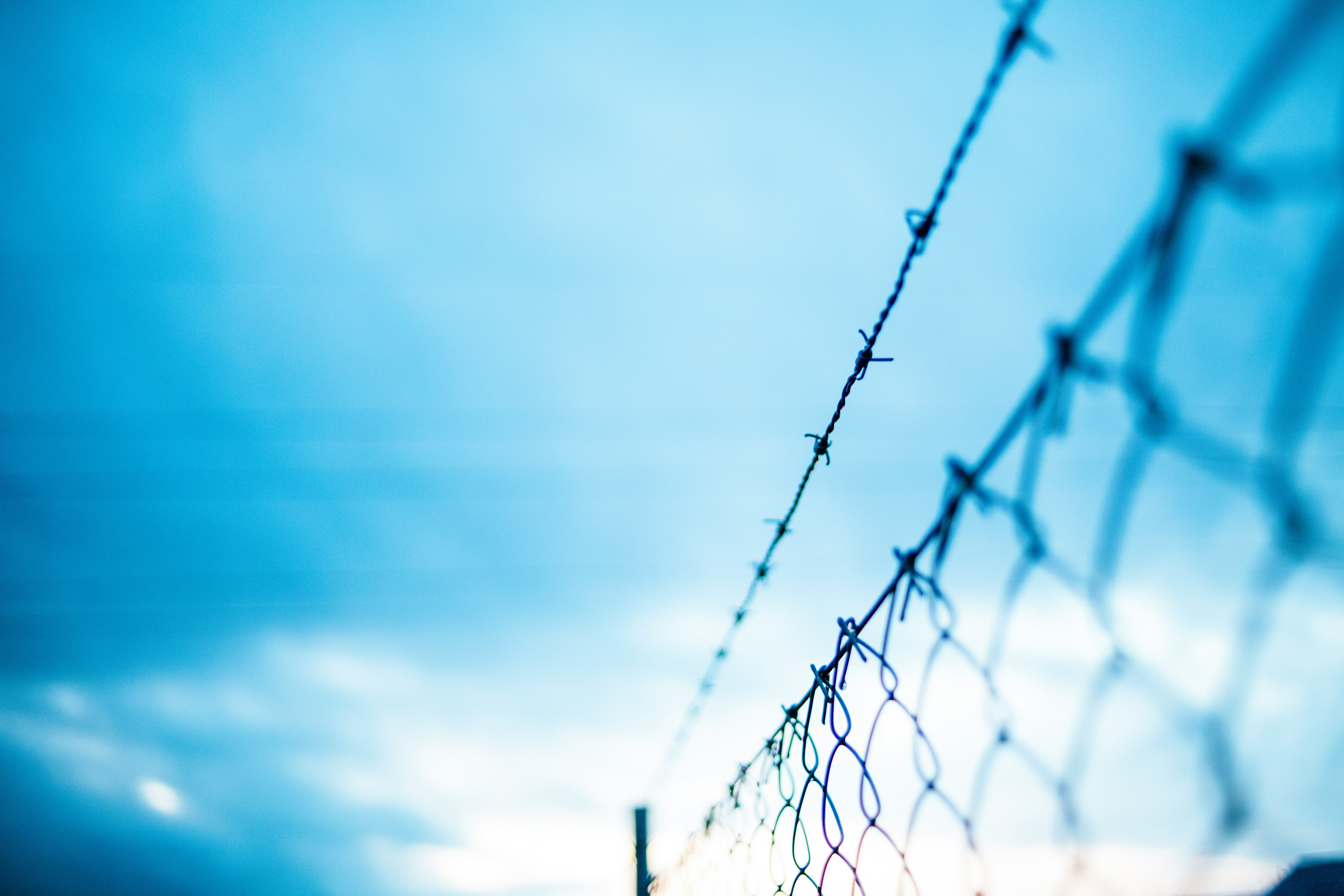 Barbed wire installed above a chain-link boundary